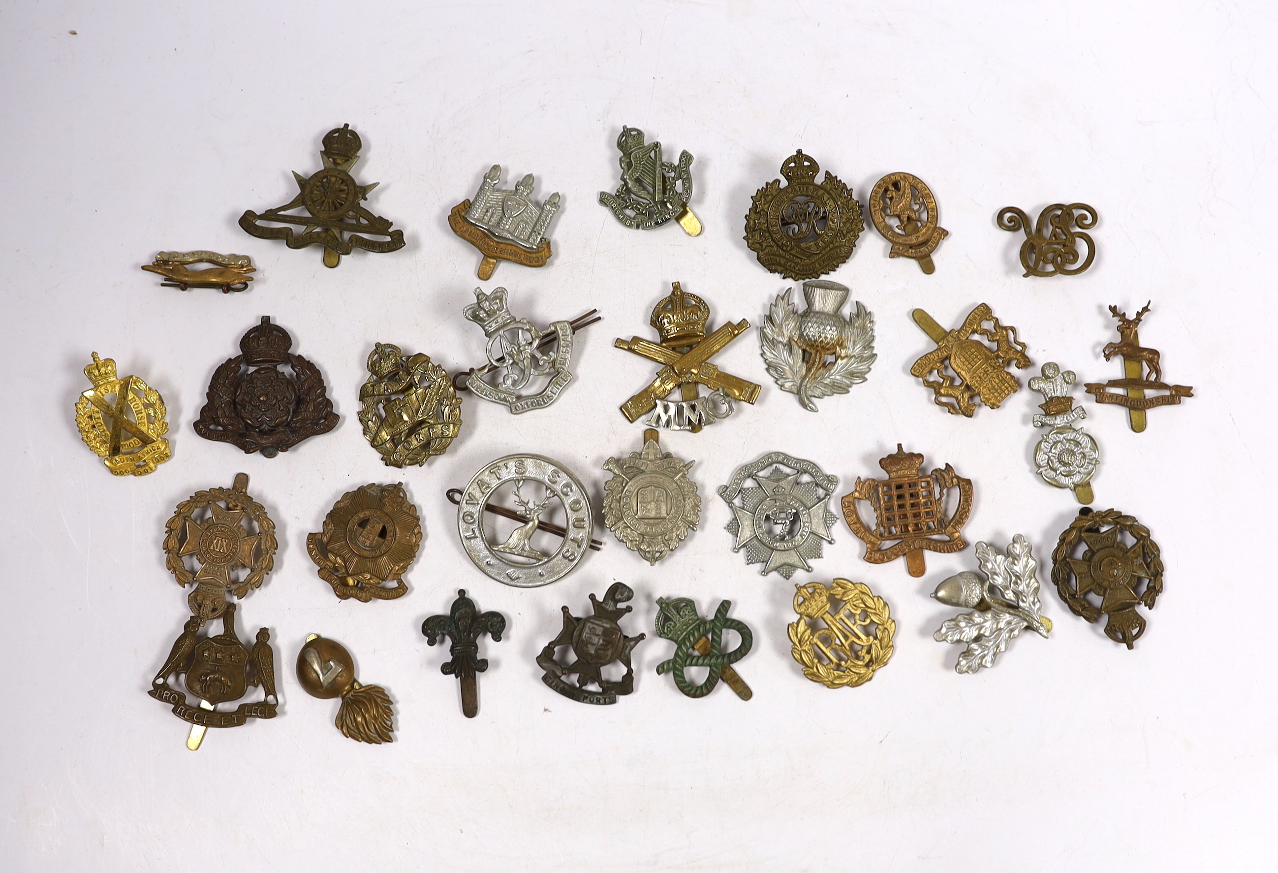 Thirty military cap badges including Royal Canadian Engineers, Royal Gloucestershire Hussars, the Robin Hoods, RAF, the Cambridgeshire Regiment, Tank Corps, Huntingdonshire, Westminster Dragoons, Cinque Ports, Derbyshire